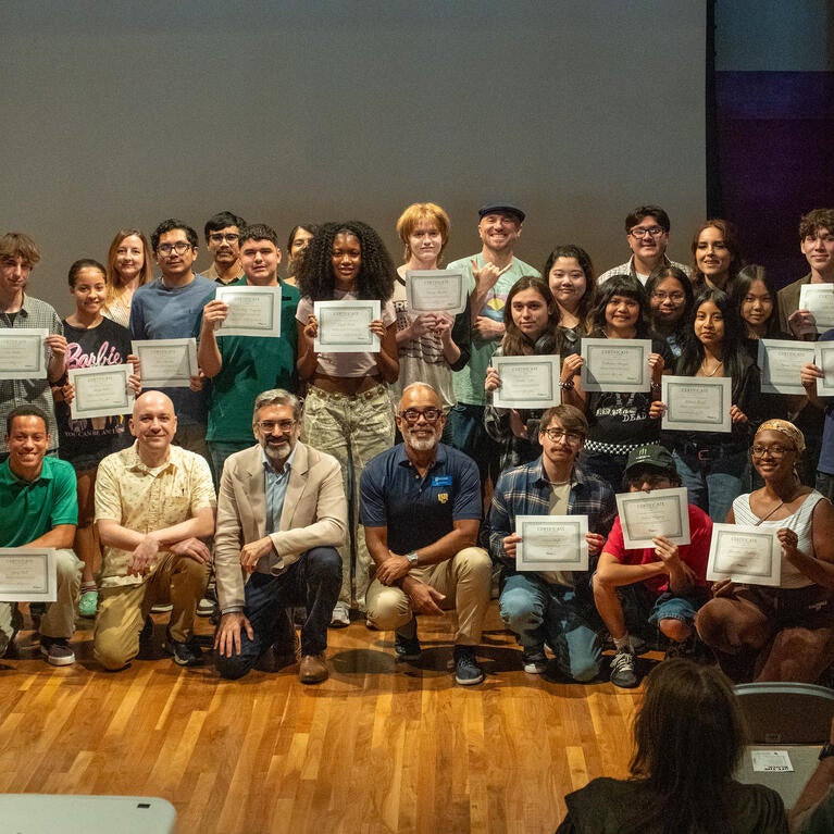 The student filmmakers holding their certificates with the program volunteers and staff. Credit: UCR / Lyndsey Rankin