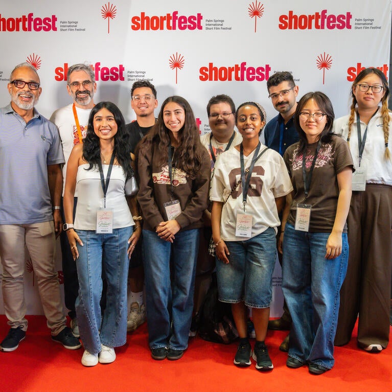 MCS and TFDP students enjoy their trip, smiling in front of the ShortFest backdrop.