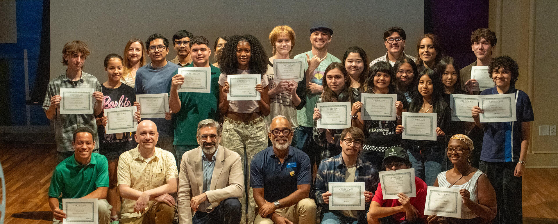 The student filmmakers holding their certificates with the program volunteers and staff. Credit: UCR / Lyndsey Rankin
