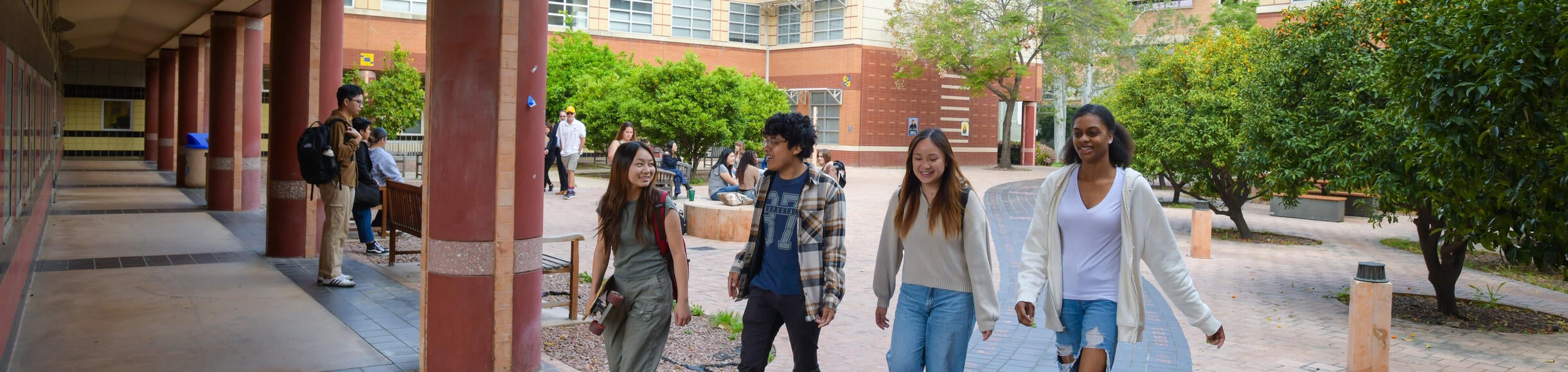 Students walking beneath the CHASS building at UC Riverside