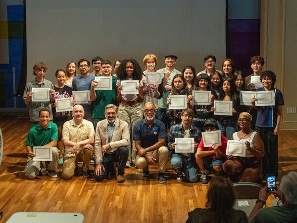 The student filmmakers holding their certificates with the program volunteers and staff. Credit: UCR / Lyndsey Rankin