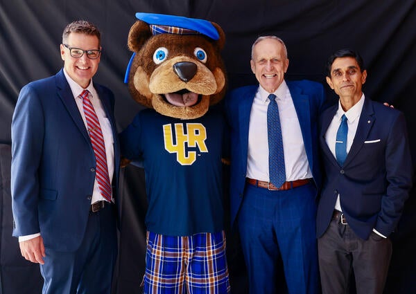 Agam Patel with Jeff Girod, Scotty the Bear, and Chancellor Kim Wilcox